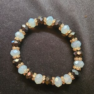 Clear Blue, Black, Gold Crystal Spacer Stretch Bracelet - a true masterpiece that combines elegance and style