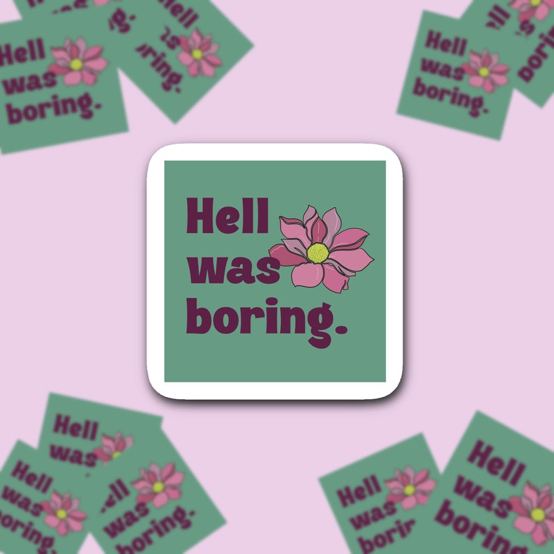 May include: Square sticker with the text "Hell was boring." in dark purple, accompanied by a pink flower with a yellow center. The sticker is on a green background with a white border. Several smaller stickers are scattered around.