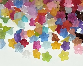 May include: Assortment of colorful plastic flower-shaped beads. The beads are translucent and come in a variety of colors, including pink, blue, green, yellow, and purple.