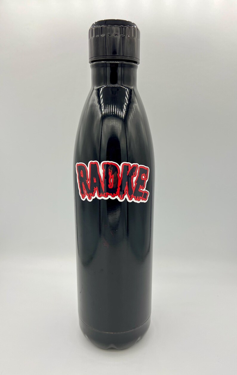 May include: Black stainless steel water bottle with a red and black "RADKE" sticker.
