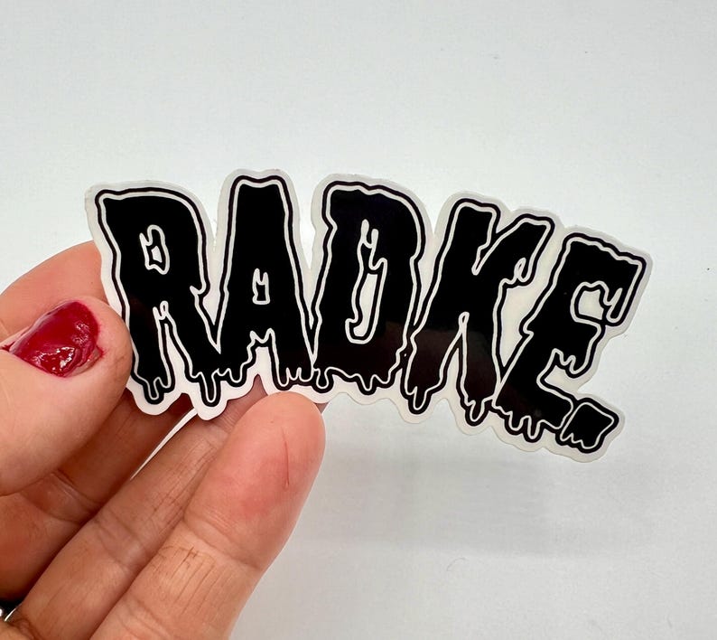 May include: Black and white sticker with the word "RADKE" in dripping letters.