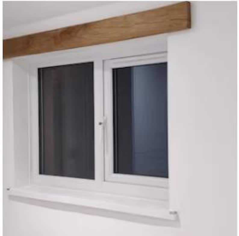 May include: White double-hung window with a wood beam above it.