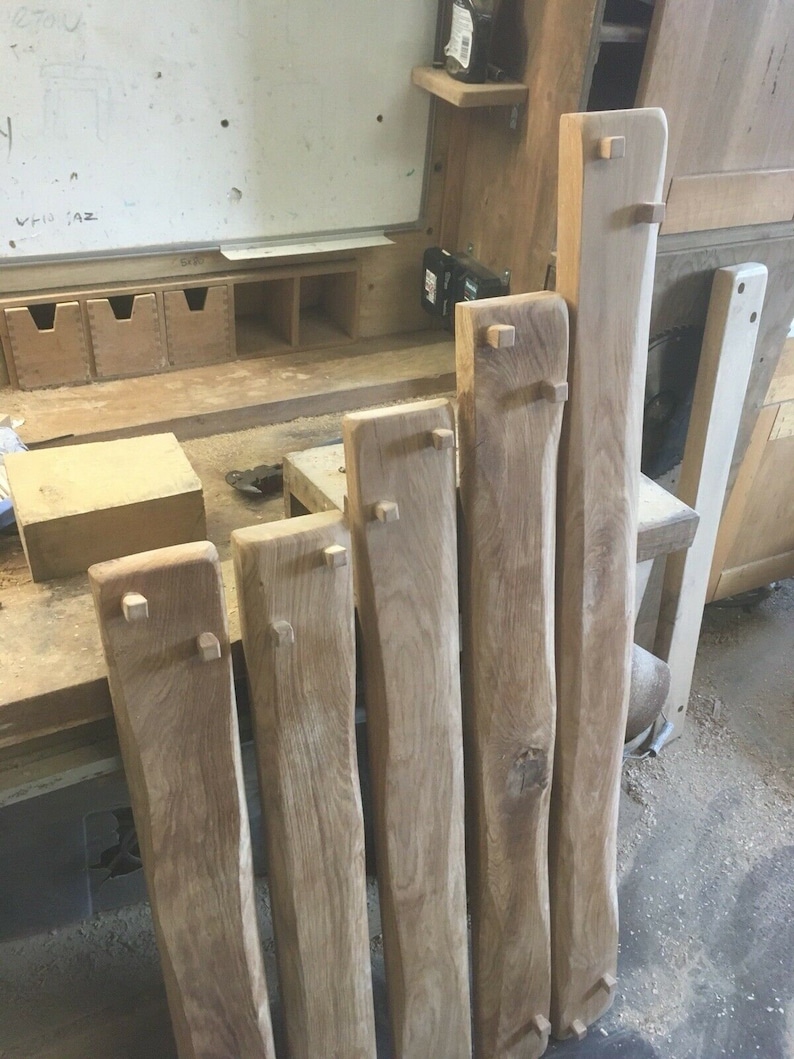 May include: Six wooden planks with square cutouts at the ends. The planks are all different lengths and have a natural wood finish.