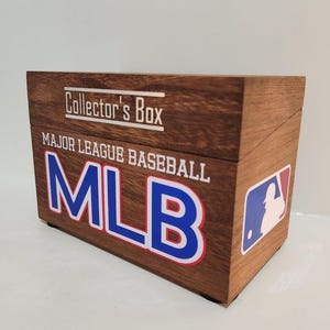May include: A rectangular wooden collector's box featuring the text Collector's Box and Major League Baseball MLB printed on the front. The box displays the official MLB logo on the right side, with a natural wood grain finish and a hinged lid design.