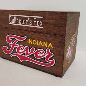 May include: A wooden box with a brown stain. The box has a white label that says "Collector's Box". The front of the box has a red and white logo that says "Fever" with the word "Indiana" in yellow letters above it.