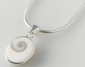 May include: A silver chain necklace with a white oval pendant featuring a spiral shell design.