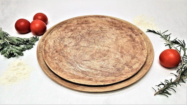 May include: A set of two brown ceramic plates with a textured surface. The plates are round and have a rustic look.