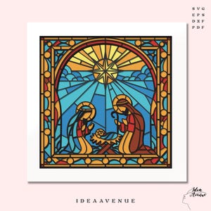 May include: A stained-glass style artwork depicting the Nativity scene. The image features Mary, Joseph, and baby Jesus in a manger, with a starburst and blue sky background. The artwork is framed with a decorative border and includes the text "IDEA AVENUE".