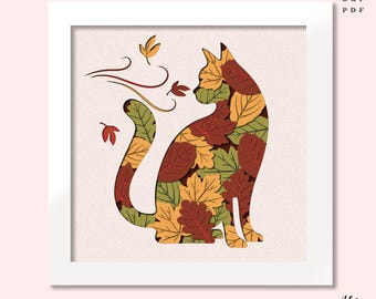May include: A framed art print featuring a cat silhouette filled with autumn leaves in shades of red, green, and yellow. The cat is seated, with a curved tail and stylized wind and leaves above. The text "IDEA AVENUE" is at the bottom.