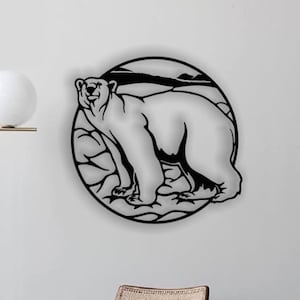 May include: A black metal wall art piece featuring a polar bear inside a circular frame. The bear is depicted standing on a textured surface, with a landscape silhouette in the background. The artwork is mounted on a white wall.