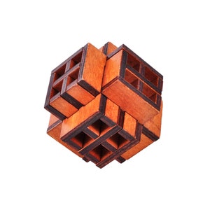 May include: A wooden puzzle cube with a complex, interlocking design. The cube is constructed from multiple rectangular wooden pieces, creating a three-dimensional structure with open spaces. The wood has a warm, reddish-brown hue with darker edges.