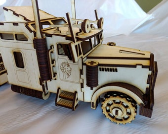 May include: A wooden model of a semi-truck with a lion logo on the side. The model is made of light brown wood and has a detailed design. The truck has a large cab with a detailed interior and a long trailer.