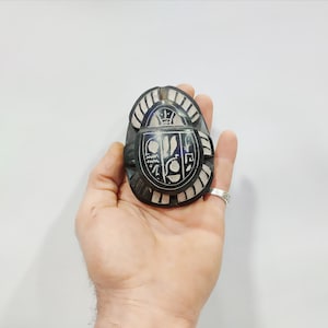 Basalt Egyptian old scarab beetles. Hieroglyphic writings cover the base . made in Egypt. 3.5 inches