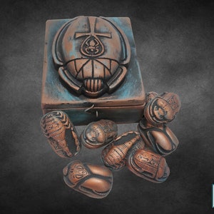 Antique Scarab Box A rare box topped with a large scarab and inside it 8 distinct scarabs, which we offer for the hobby of collecting rare