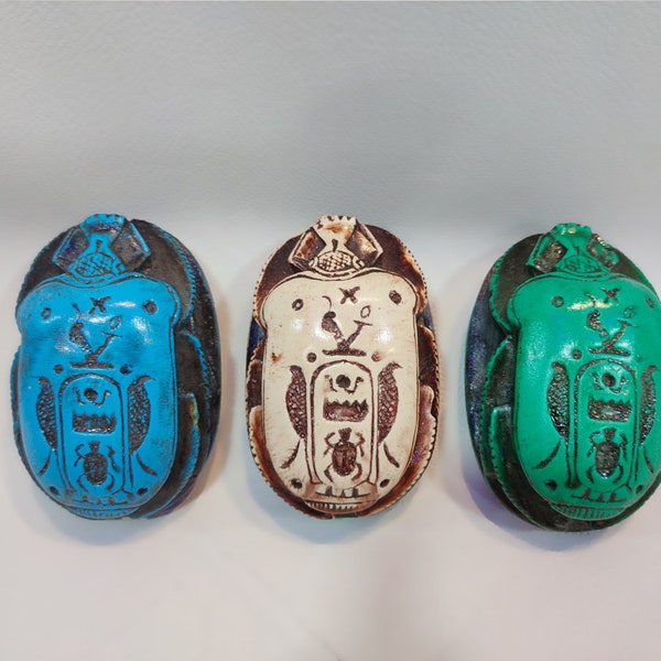 scarab. Egyptian scarabs beetles. Hieroglyphic writings cover the base . Available in three wonderful colors. Made in Egypt. 3.5 inches