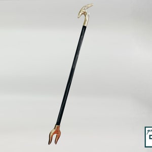 May include: A black walking stick with a silver animal head handle and a silver forked tip.