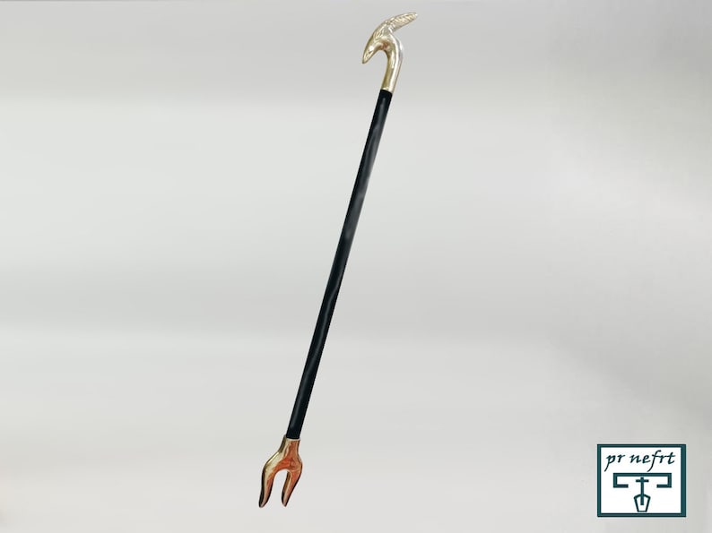 May include: A black walking stick with a silver animal head handle and a silver forked tip.