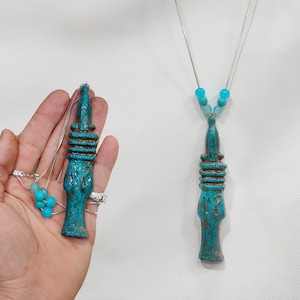 Djed necklace. Amulet of the Djed of God Osiris. Djed .  Djed pillar representing Osiris&#39; backbone bearing . made Iin egypt