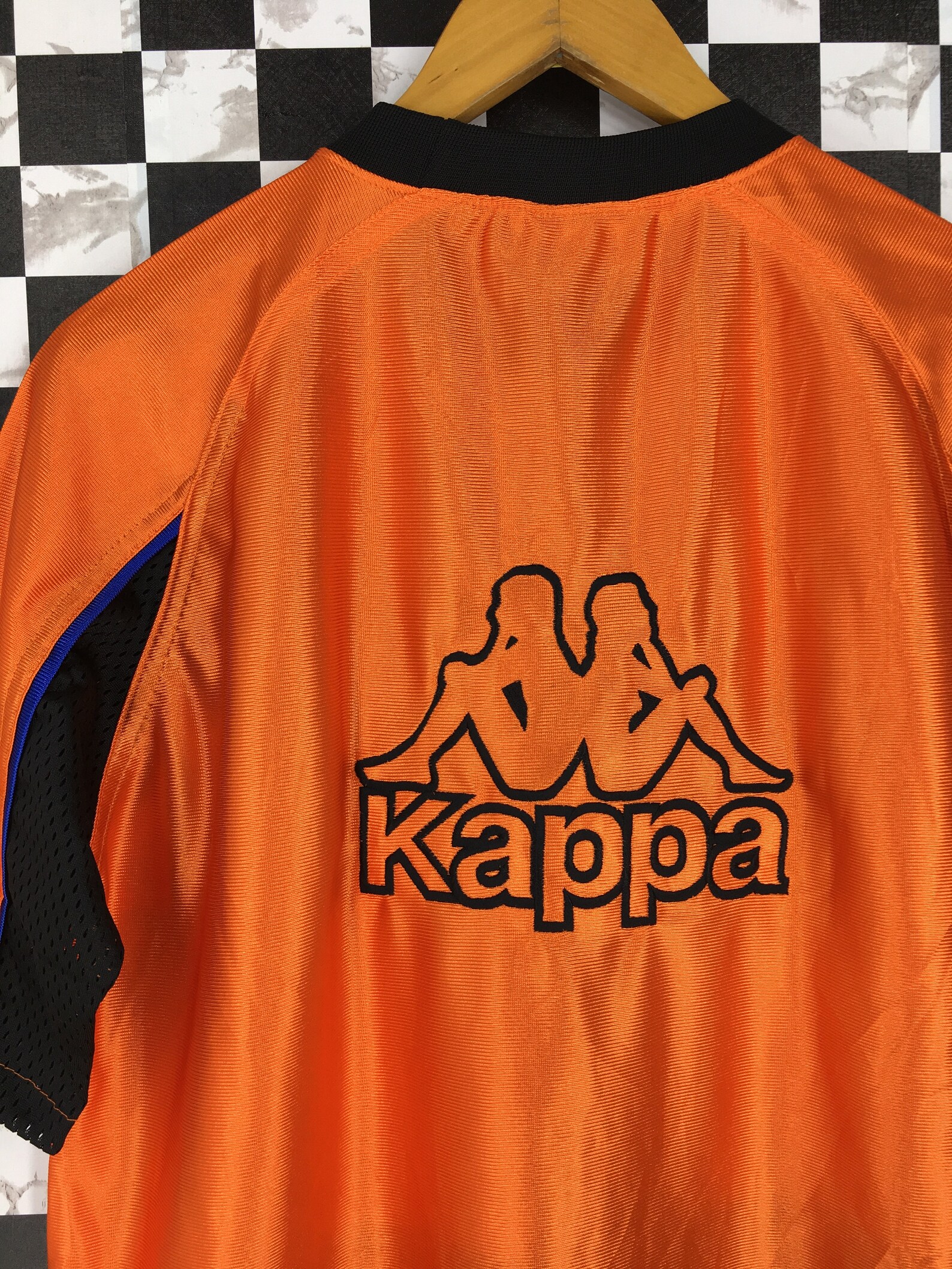 white and orange kappa shirt