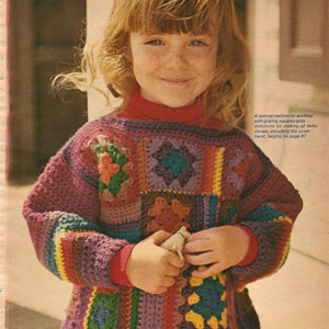 May include: A young girl wearing a colorful crocheted sweater with a granny square pattern. The sweater has a variety of colors, including purple, green, yellow, and red.