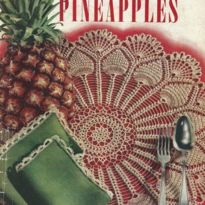 May include: A vintage crochet pattern booklet featuring a pineapple design. The cover features a pineapple, a crocheted doily, and two placemats. The title of the booklet is "The Pick of the Pineapples".