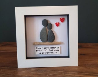 Every love story...  pebble couple. Framed pebble picture