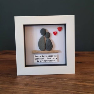 Every love story...  pebble couple. Framed pebble picture