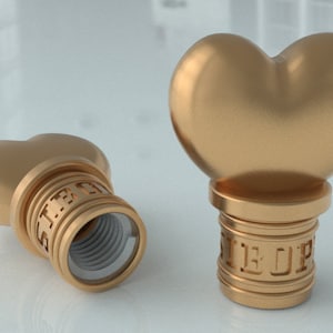 May include: Two gold-colored heart-shaped bottle stoppers with the word "STOP" engraved on the base.