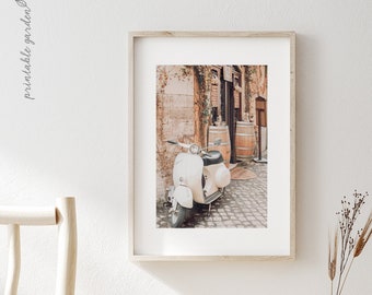 May include: A white vintage scooter parked on a cobbled street in front of a building with a wooden door and barrels. The building has a stone facade and vines growing on the wall.