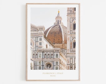 May include: A photograph of the Duomo in Florence, Italy. The image shows the intricate details of the cathedral's facade and dome, with a light brown and white color scheme.