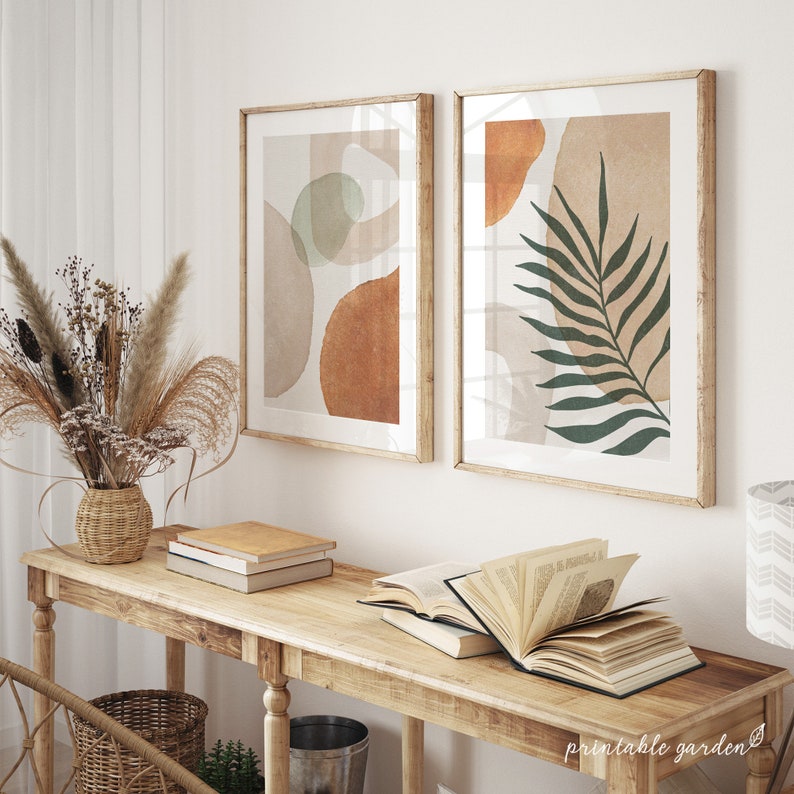 Minimalist abstract artwork featuring warm terracotta, beige shapes, and a bold palm leaf silhouette. Printable boho botanical wall decor.