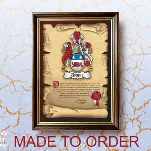 May include: A framed certificate with a coat of arms featuring a red, white, and blue shield with a lion and stars. The text "Angus" is printed below the shield. The certificate is on parchment paper with a brown background and a gold frame.