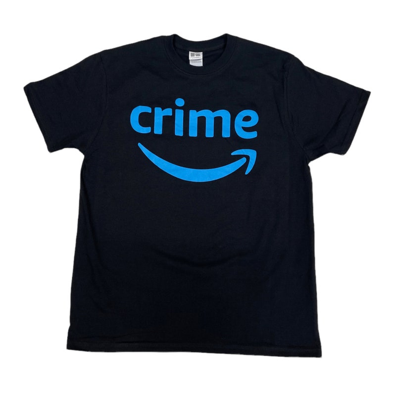 May include: Black t-shirt with a blue Amazon logo and the word "crime" printed on the front.
