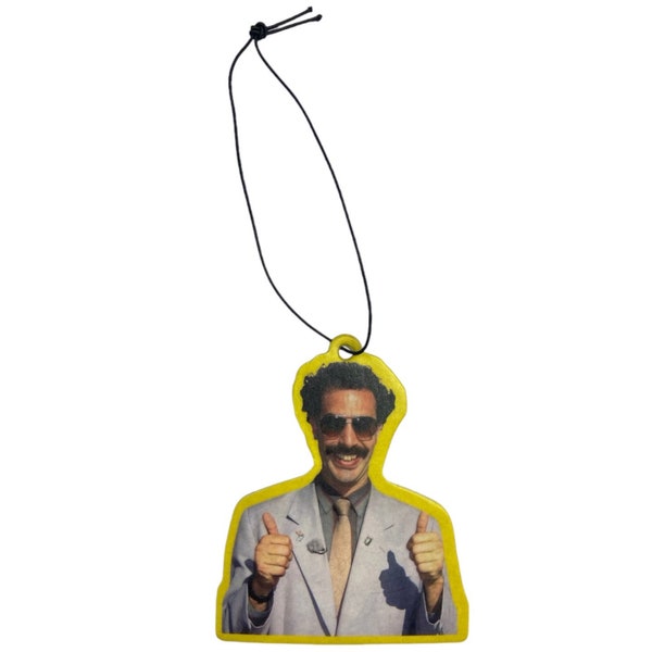 May include: Yellow car air freshener with a picture of a man with curly hair, sunglasses, and a mustache giving a thumbs up with both hands.