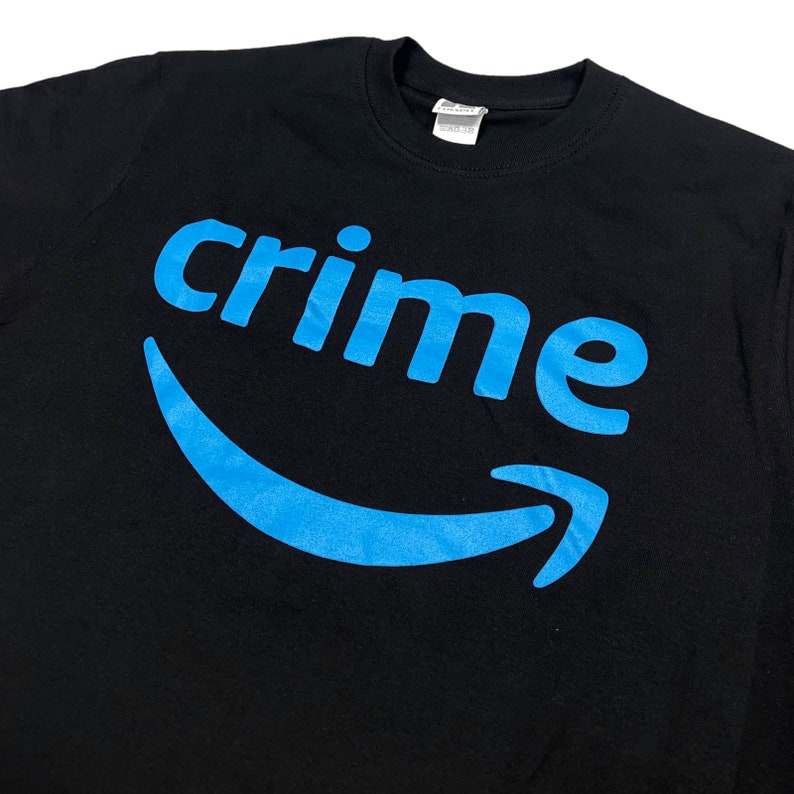 May include: Black t-shirt with a blue Amazon logo and the word "crime" printed on it.