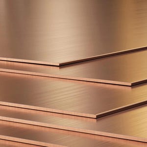 May include: Stack of four copper sheets with a brushed finish. The sheets are arranged in a staggered pattern, creating a layered effect.