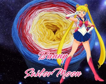 May include: A ball of yarn with blue, red, white, and yellow stripes. The yarn is in the shape of a circle and has a hole in the center. The yarn is surrounded by a black background with stars. The text "Bunny Sailor Moon" is written in white letters on the yarn.