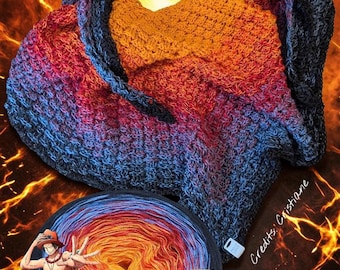 May include: A crocheted cowl in shades of blue, red, and orange, resembling flames. A matching ball of yarn with a cartoon character and the name "Ace" is also visible. The background has a fiery effect.