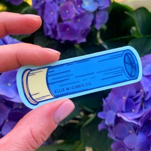 May include: A blue and yellow sticker of a shotgun shell with the text "ELLIE McGINNIS CO."