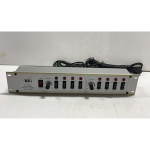 May include: A silver 8-channel switch control unit with a timer, featuring a black power switch, two rotary timer speed knobs, and eight individual black toggle switches with red indicator lights. The front panel displays the text PC-9400S.