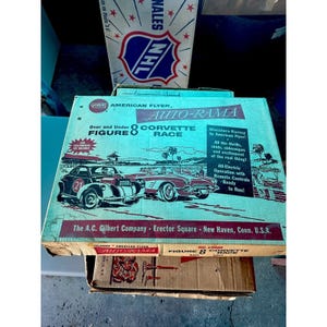 May include: Vintage American Flyer Auto-Rama Figure 8 Corvette Race set box. The box features illustrations of classic cars and text that reads "Miniature Racing by American Flyer!" and "All-Electric Operation with Remote Controls."