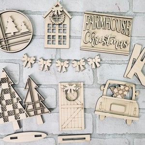 May include: Wooden craft supplies for a farmhouse Christmas theme. The set includes a sign that says "Farmhouse Christmas", a house with a wreath, a tree, a truck with a tree, a door with a wreath, and a set of bows.