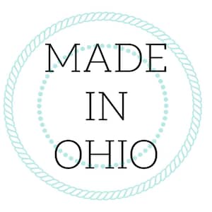 K&ouml;nnte beinhalten: Ein blauer Seilkranz mit wei&szlig;en Punkten am Rand. Der Text im Kreis lautet "MADE IN OHIO".