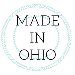 May include: A blue rope circle with white dots around the edge. The text inside the circle reads "MADE IN OHIO".