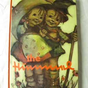 May include: Vintage hardcover book titled "the Himmel." The cover features a colorful illustration of two children under an umbrella, with the title in orange lettering. The book has an orange spine.