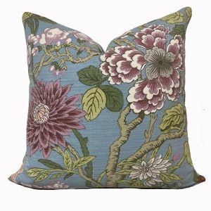 May include: A blue pillow with a floral pattern featuring pink, purple, and green flowers on a light blue background.