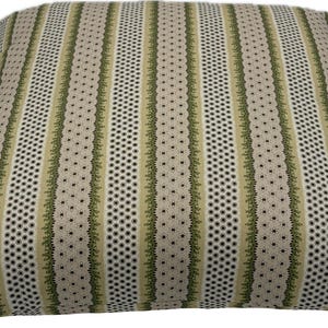 May include: Square decorative pillow with a striped pattern. The pillow features vertical stripes in beige, olive green, and black. The design includes dotted and floral elements, creating a textured appearance. The pillow is suitable for home decor.