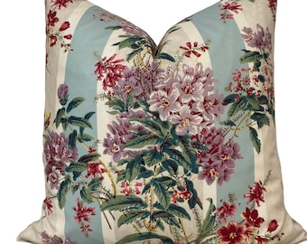Può includere: Un cuscino decorativo con un motivo floreale su uno sfondo a strisce blu e bianco. I fiori sono rosa, rossi e verdi.