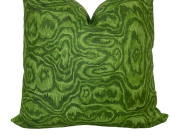 May include: Green throw pillow with a swirling, abstract pattern.