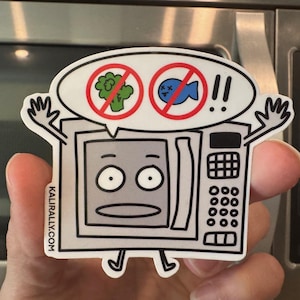 May include: A white sticker featuring a cartoon microwave with arms and legs. The microwave has a surprised expression and a speech bubble with a broccoli and fish symbol crossed out. The website address is visible on the side.
